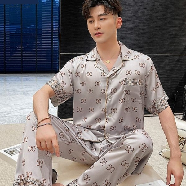 Bộ đồ ngủ lụa nam tay ngắn màu xám họa tiết chữ, dáng rộng thoải mái ngồi trong phòng khách