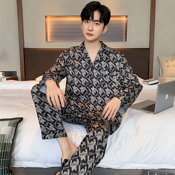 Bộ pijama nam dài tay họa tiết chữ màu đen xám mặc trong phòng ngủ hiện đại