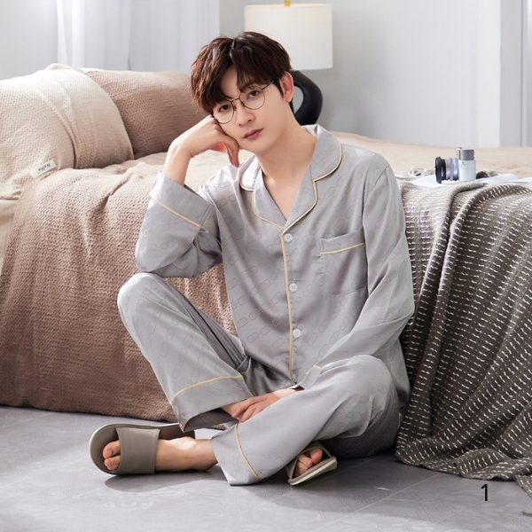 Bộ pijama lụa dài tay màu xám cho nam ngồi trên sàn cạnh giường ngủ