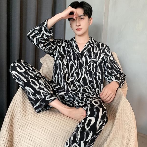 Bộ pijama nam dài tay màu đen họa tiết chữ trắng chất liệu mỏng nhẹ ngồi trên ghế sofa