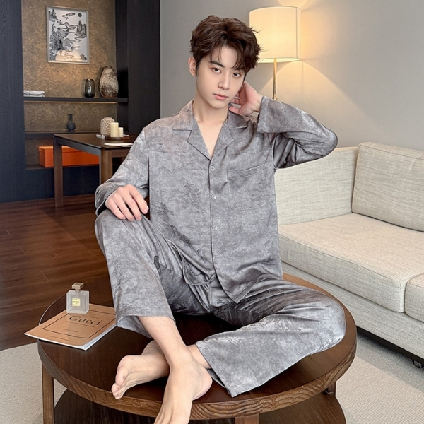 Nam giới mặc bộ pijama lụa màu xám ngồi trên bàn tròn trong phòng khách hiện đại