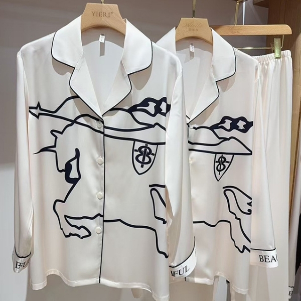 Bộ pijama lụa màu trắng in hình ngựa viền đen treo trên móc gỗ