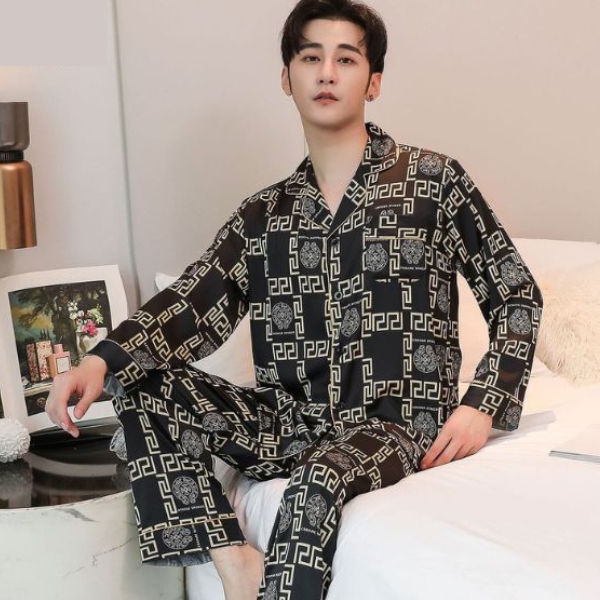 Bộ pijama nam lụa dài tay màu đen họa tiết hình học ngồi trên giường trong phòng ngủ