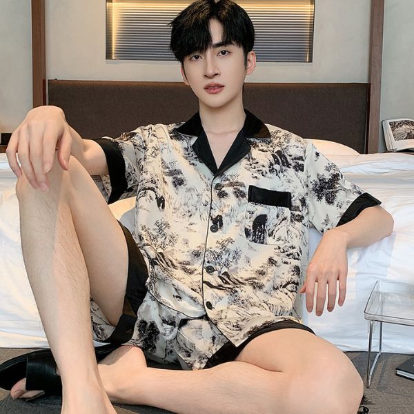 Nam giới mặc bộ pijama lụa họa tiết phong cảnh màu trắng đen ngồi trên giường trong phòng ngủ